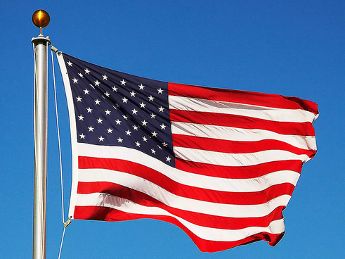 American flag flying against a blue sky
